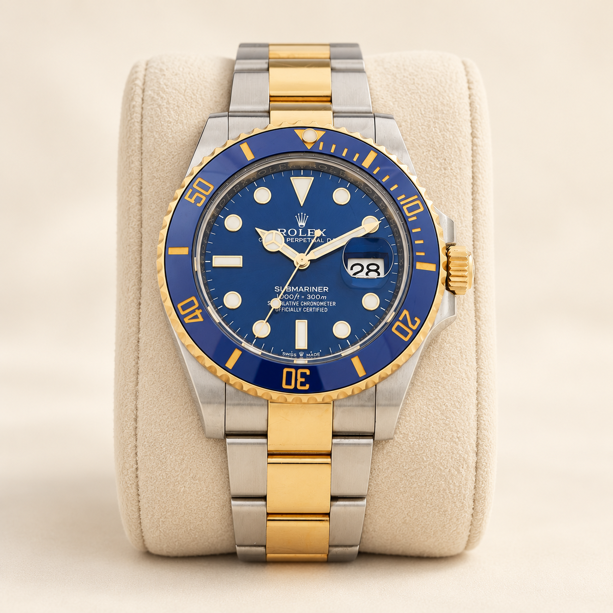 Representative blue-dial two-tone Submariner styled on a cream pillow